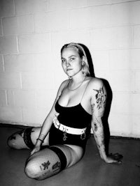 a black and white photo of a woman sitting on the floor