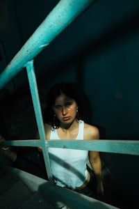 a woman wearing a white tank top