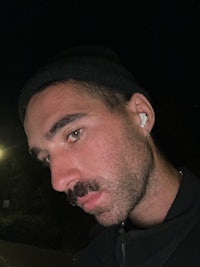 a man wearing a beanie and a mustache