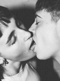 a black and white photo of two people kissing