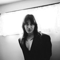 a black and white photo of a woman with tattoos